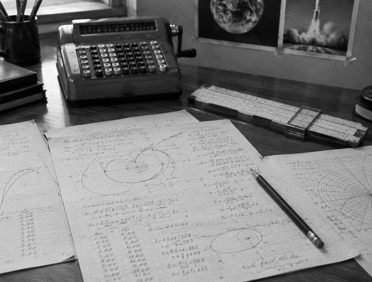 Hand-written orbital calculations and a mechanical calculator, the tools of Katherine Johnson's era